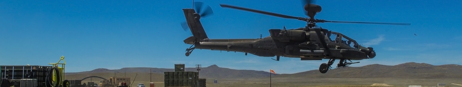 an AH-64D apache takes off from a FARP